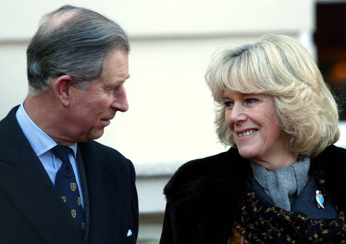 Britain’s Prince Charles stands beside his smiling fiancee Camilla Parker Bowles during an engagemen..