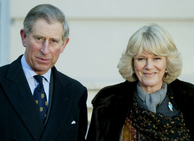 Britain’s Prince Charles stands with his fiancee Camilla Parker Bowles during an engagement at Clare..