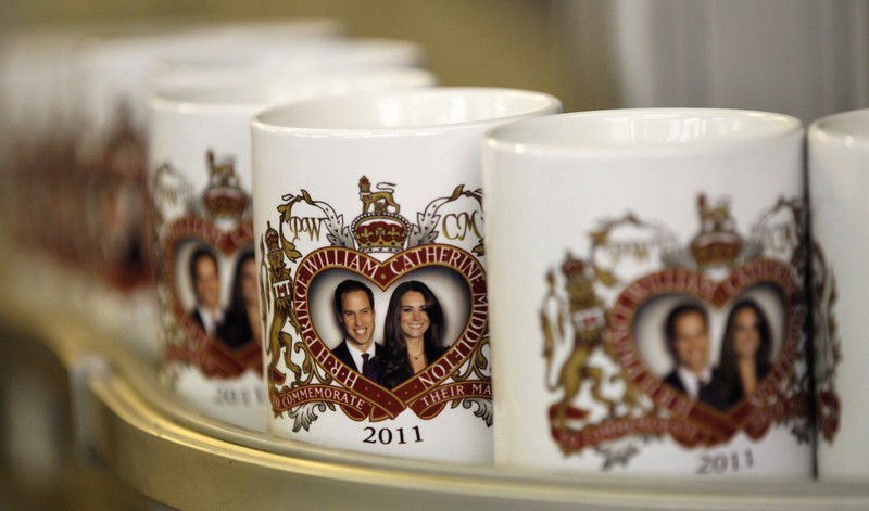 Mugs commemorating the engagement of Britain’s Prince William to Kate Middleton move along a conveyor belt in Liverpool