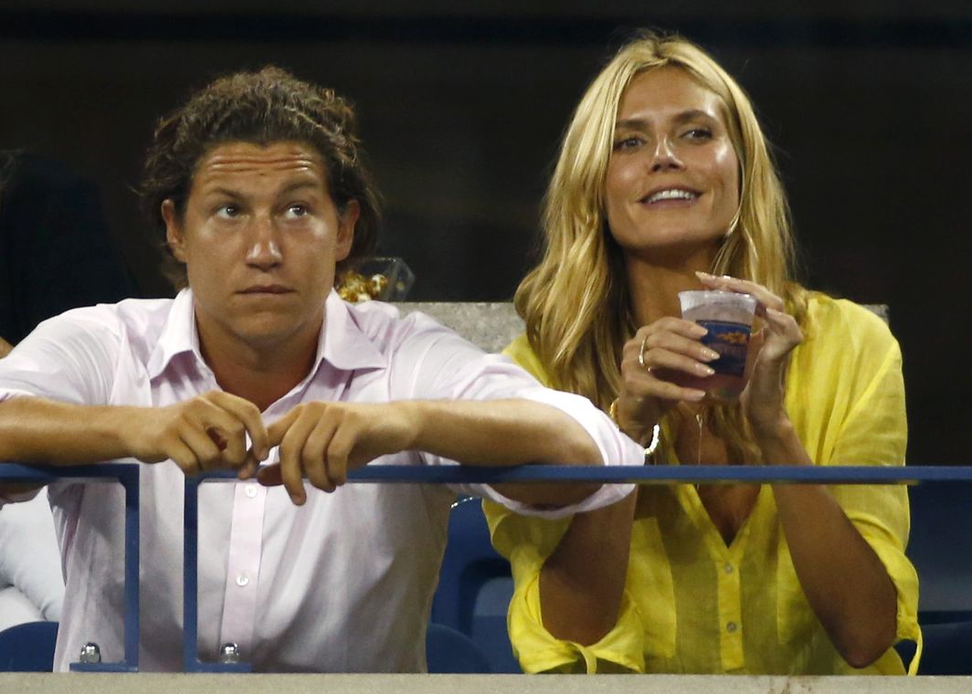 Heidi Klum sits next to Vito Schnabel as they watch men’s singles match between Milos Raonic of Canada and Kei Nishikori of Japan at the 2014 U.S. Open tennis tournament in New York
