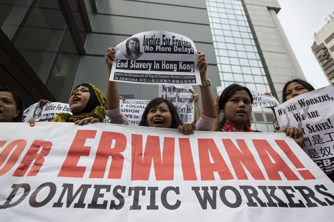 A supporter holds a sign with a drawing of Indonesian domestic helper Erwiana Sulistyaningsih, during a protest calling for better protection of migrant workers, outside the Kwun Tong Magistrates’ Court in Hong Kong
