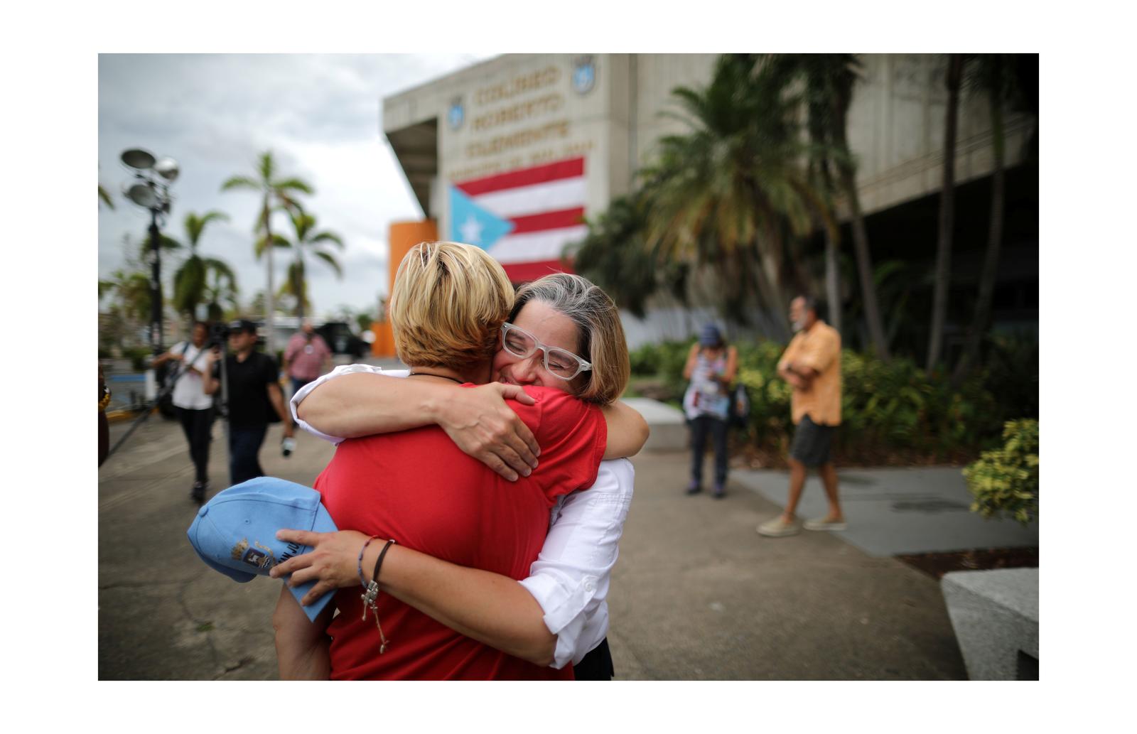 Mayor of San Juan Carmen Yulin Cruz embraces Esperanza Ruiz, a city administrator, outside the government center at the Roberto Clemente Coliseum after Hurricane Maria, in San Juan