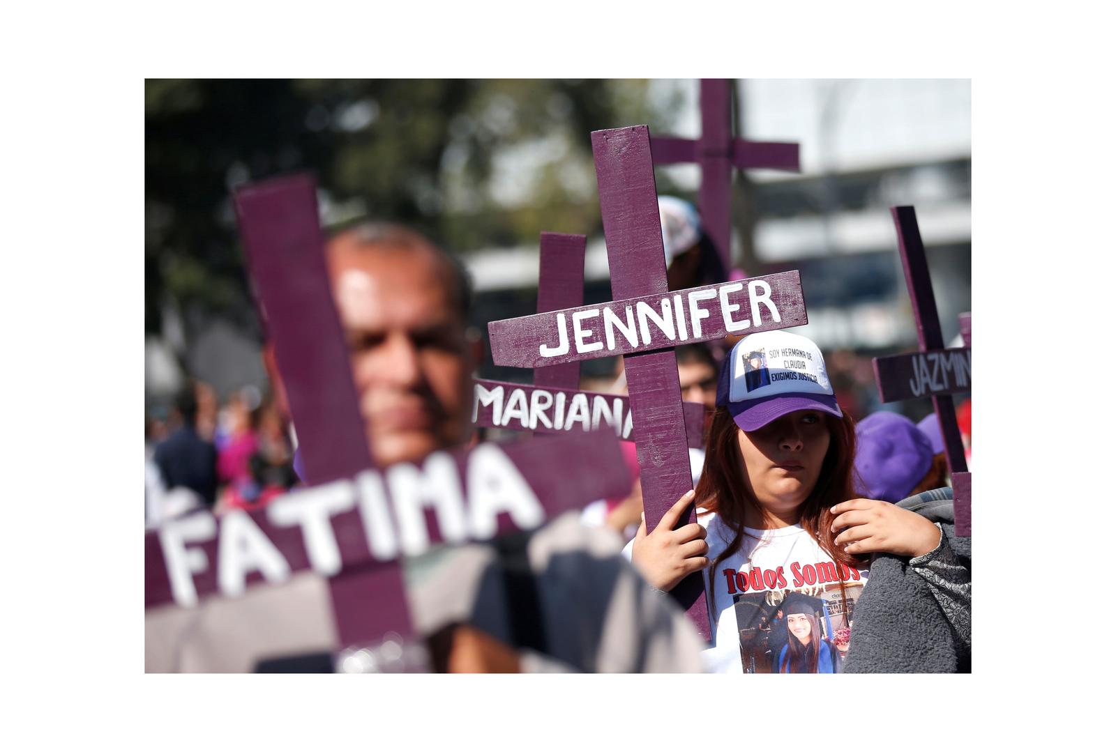 Demonstrators and relatives of women who were either murdered or disappeared take part in a march during the International Day for the Elimination of Violence Against Women, in Mexico City