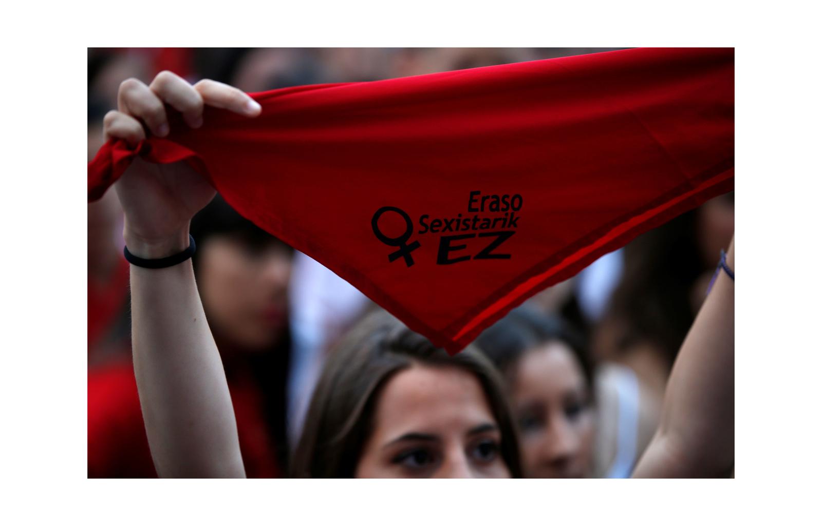 A woman holds a San Fermin red scarf with the phrase “No to sexual aggressions” during a protest against sexual violence against women during the San Fermin festival in Pamplona