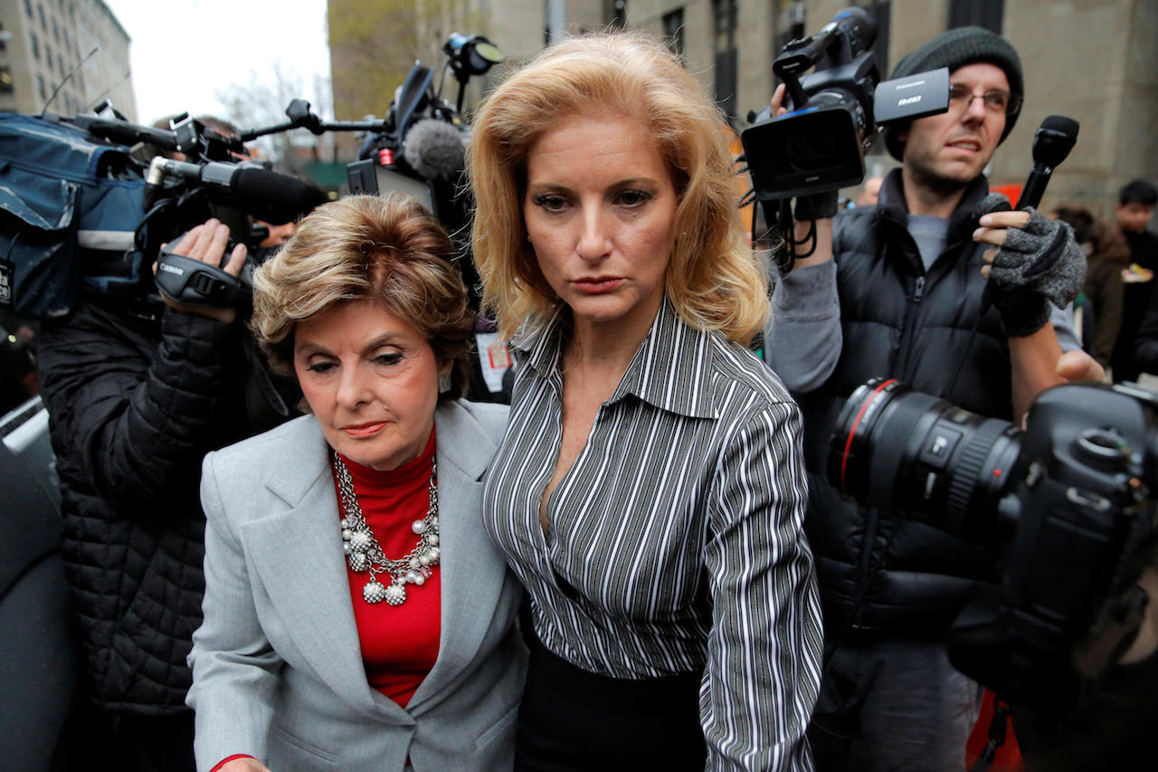 Zervos, a former contestant on The Apprentice, leaves New York State Supreme Court with attorney  Allred in Manhattan, New York