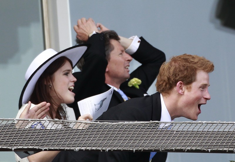 Britain’s Princess Eugenie and and Prince Harry watch the Epsom Derby at Epsom Racecourse in southern England