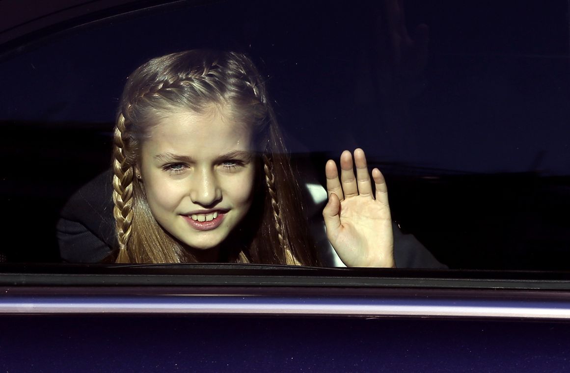 Spain’s Princess Leonor waves from her car at the end of a military parade outside Parliament after a ceremony to inaugurate the XII Legislature in Madrid