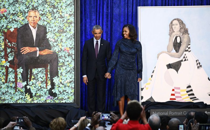 Former U.S. President Obama and first lady Michelle Obama stand with portraits during unveiling ceremony at the Smithsonians National Portrait Gallery in Washington