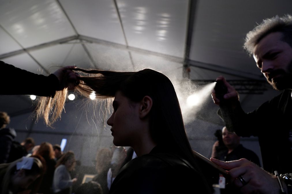 A model is prepared backstage before the Carla Pontes Fall/Winter 2018/19 collection show during Portugal Fashion in Porto
