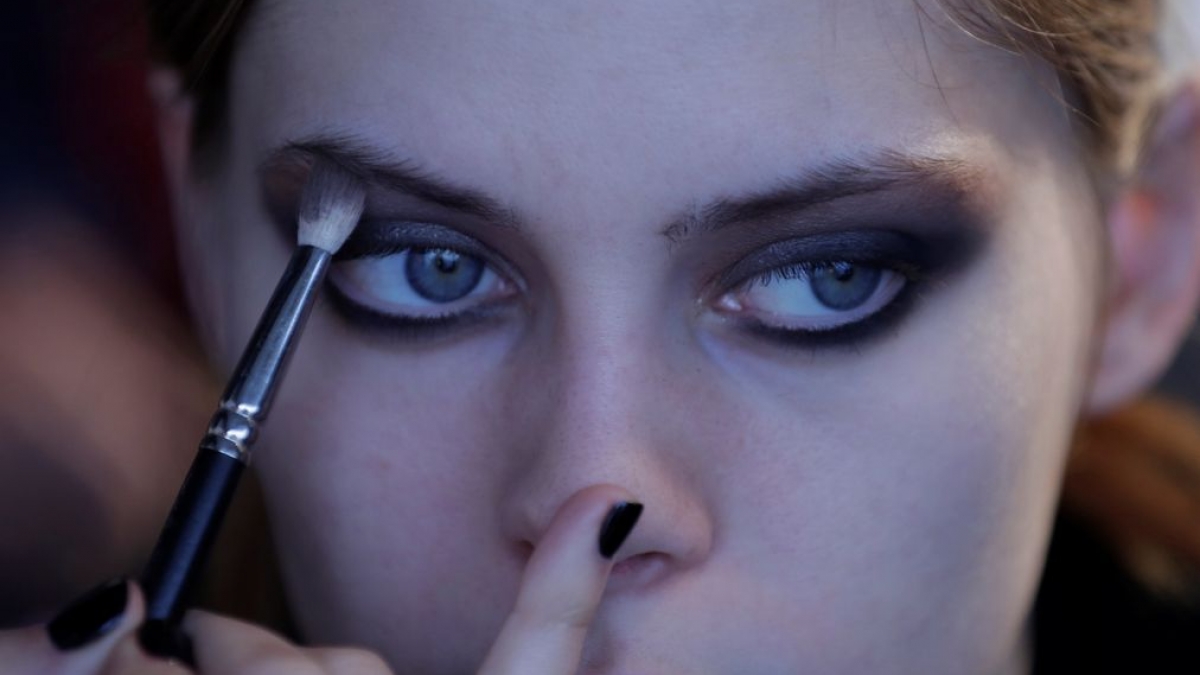 A model gets ready at the backstage before the Concreto collection show during Portugal Fashion in Porto, Portugal