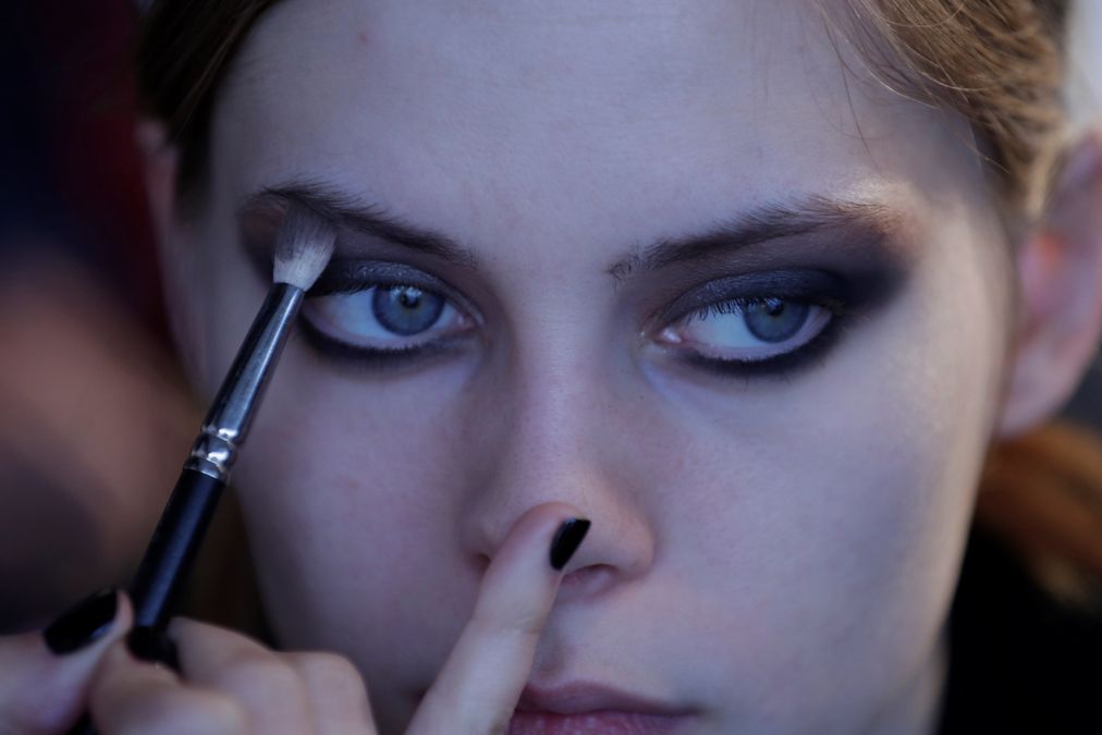 A model gets ready at the backstage before the Concreto collection show during Portugal Fashion in Porto, Portugal