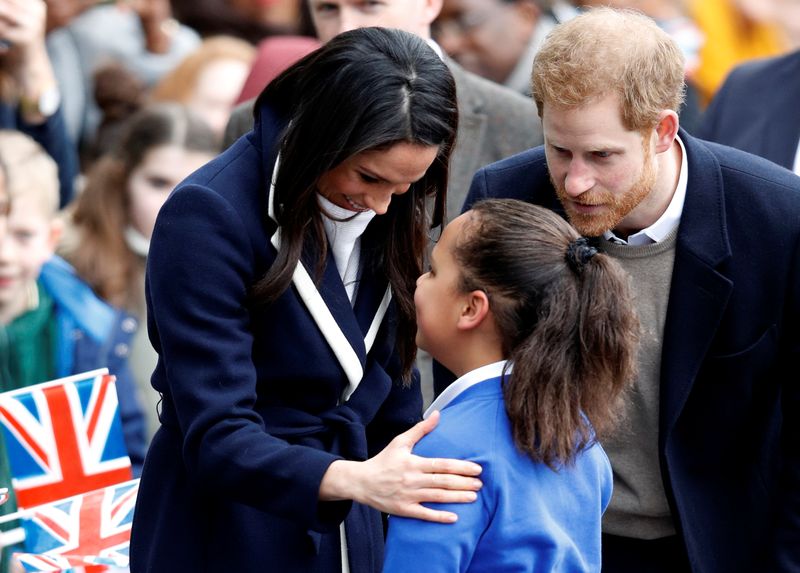 Britain’s Prince Harry and his fiancee Meghan Markle meet local school children during a walkabout on a visit to Birmingham