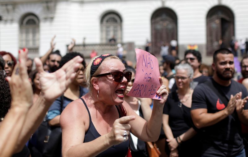 Demonstrators react outside the city council chamber ahead of the wake of Rio de Janeiro’s city councillor Marielle Franco, 38, who was shot dead, in Rio de Janeiro