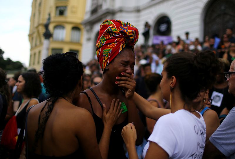 Mourners react outside the city council chamber ahead of the wake of Rio de Janeiro’s city councillor Marielle Franco, 38, who was shot dead, in Rio de Janeiro