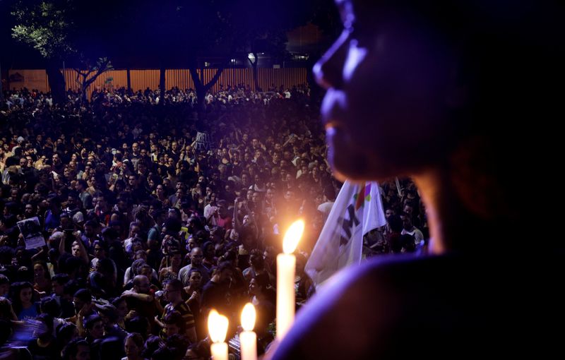 A demonstrator reacts during a rally against the death of Rio de Janeiro city councilor Marielle Franco, who was shot dead in Rio de Janeiro, Brazil