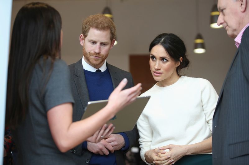 The fiancee of Britain’s Prince Harry, Meghan Markle, listens during a visit to a science park called Catalyst Inc., in Belfast