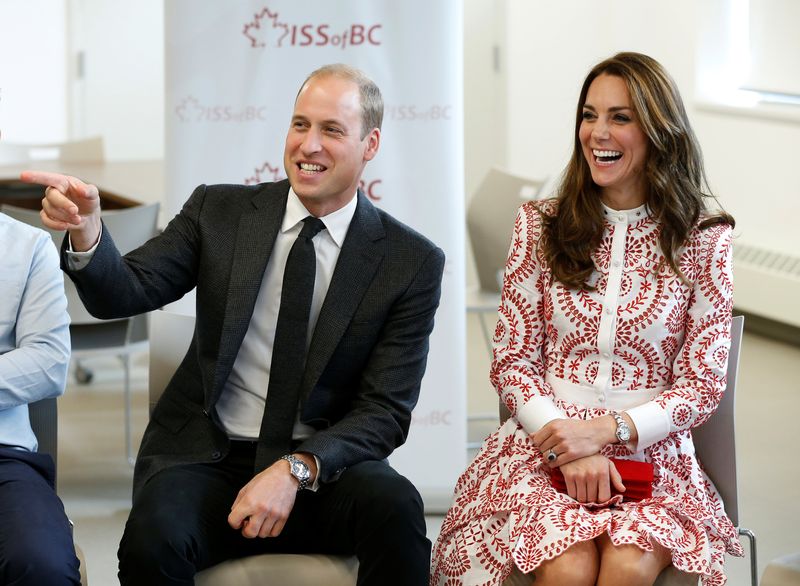 Britain’s Prince William and Catherine, Duchess of Cambridge, react during a visit to the Immigrant Services Society in Vancouver, British Columbia