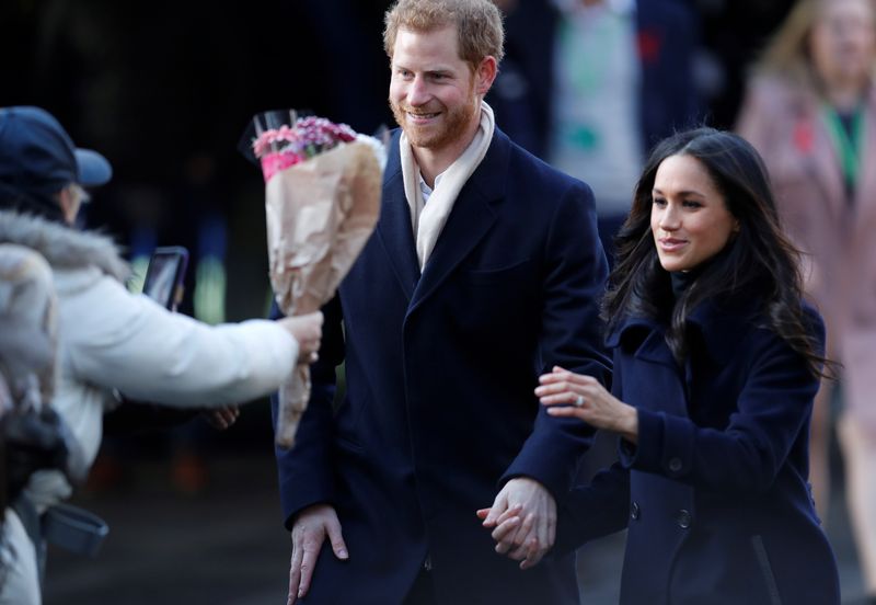 Britain’s Prince Harry and his fiancee Meghan Markle greet well wishers as they arrive at an event in Nottingham