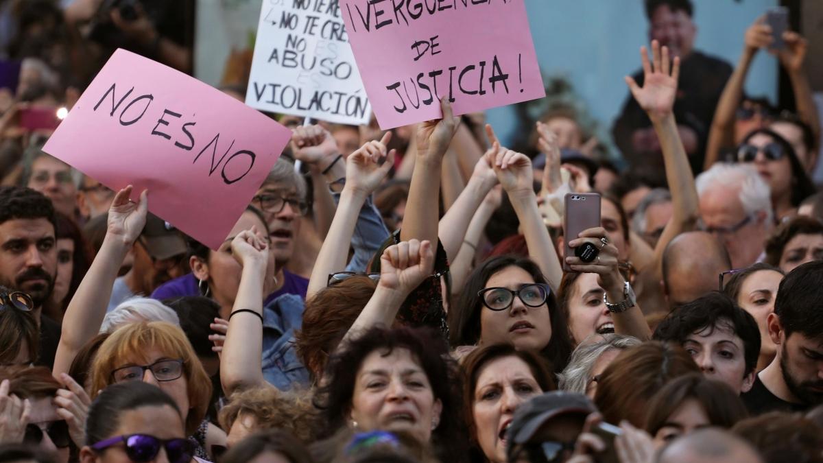 People shout slogans during a protest outside Ministry of Justice in Madrid