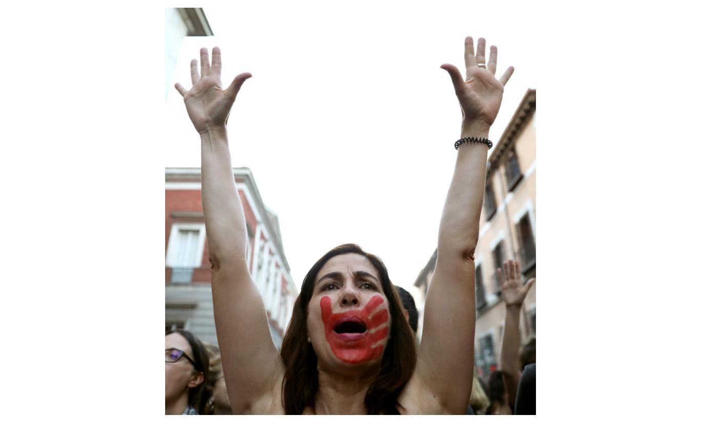 A woman raises her arms during a protest outside Ministry of Justice in Madrid