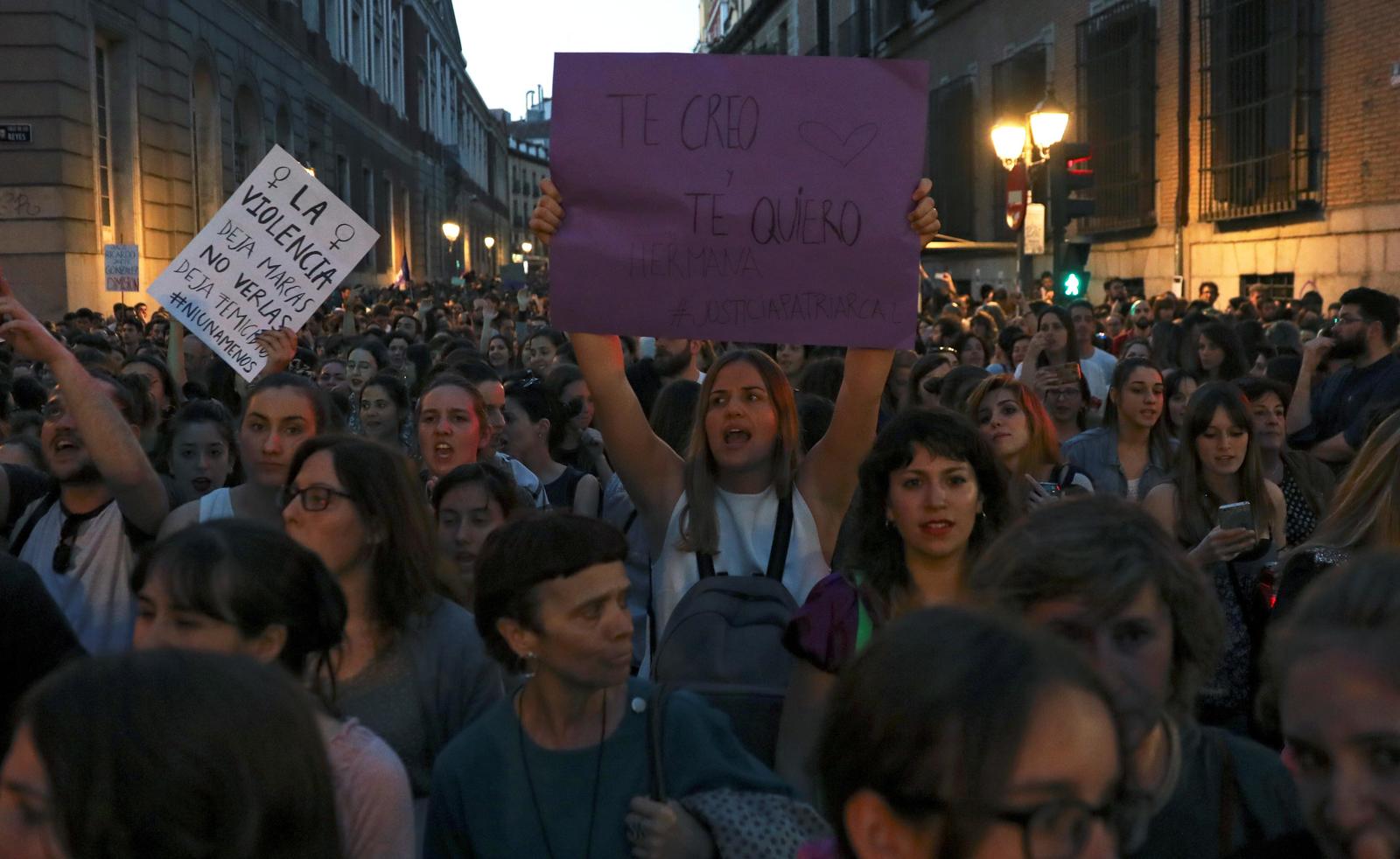 A woman holds up a placard during a protest outside Ministry of Justice in Madrid