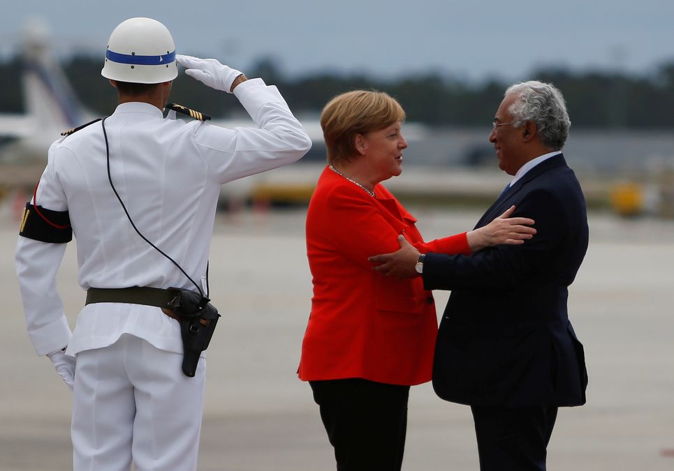 German Chancellor Angela Merkel greets Portuguese Prime Minister Antonio Costa during a welcoming ceremony at the start of a two-day official visit in Porto