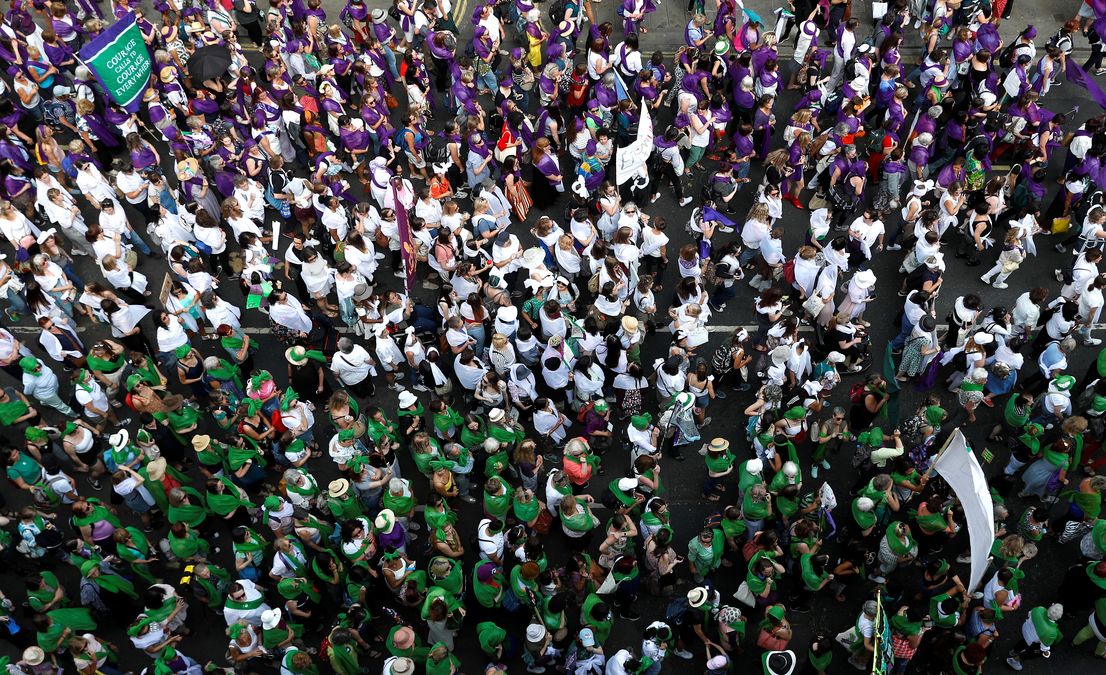 Women wear coloured clothes and march in a colour coordinated way to show the suffragette colours of green, white and violet – standing for Give Women Votes – in the ‘Processions’ women’s march in London