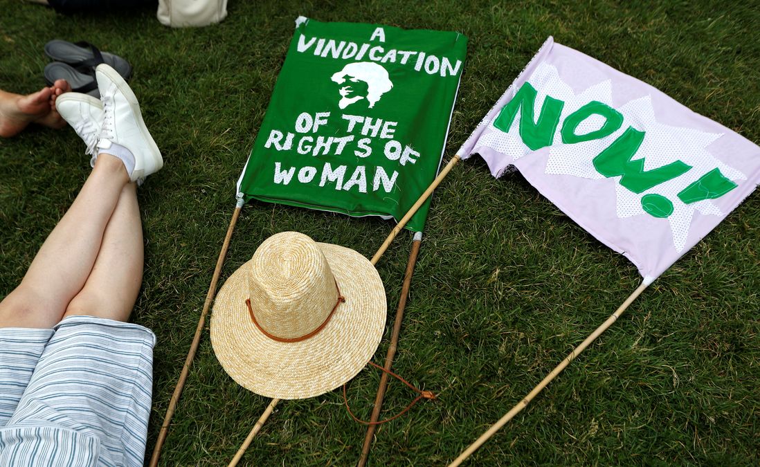 Banners in the suffragette colours of green, white and violet – standing for Give Women Votes – lie on the grass next to the statue of Millicent Fawcett during the ‘Processions’ women’s march in Westminster, London