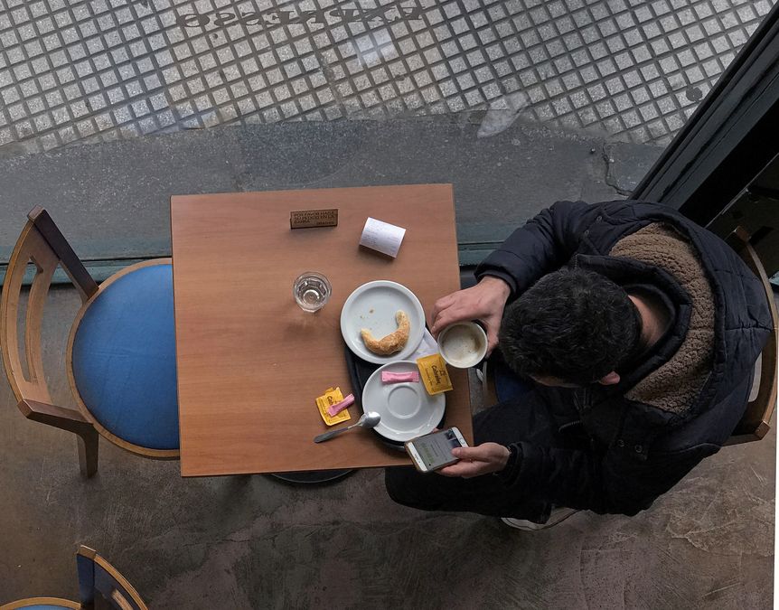 A man has breakfast at a coffee store in Buenos Aires