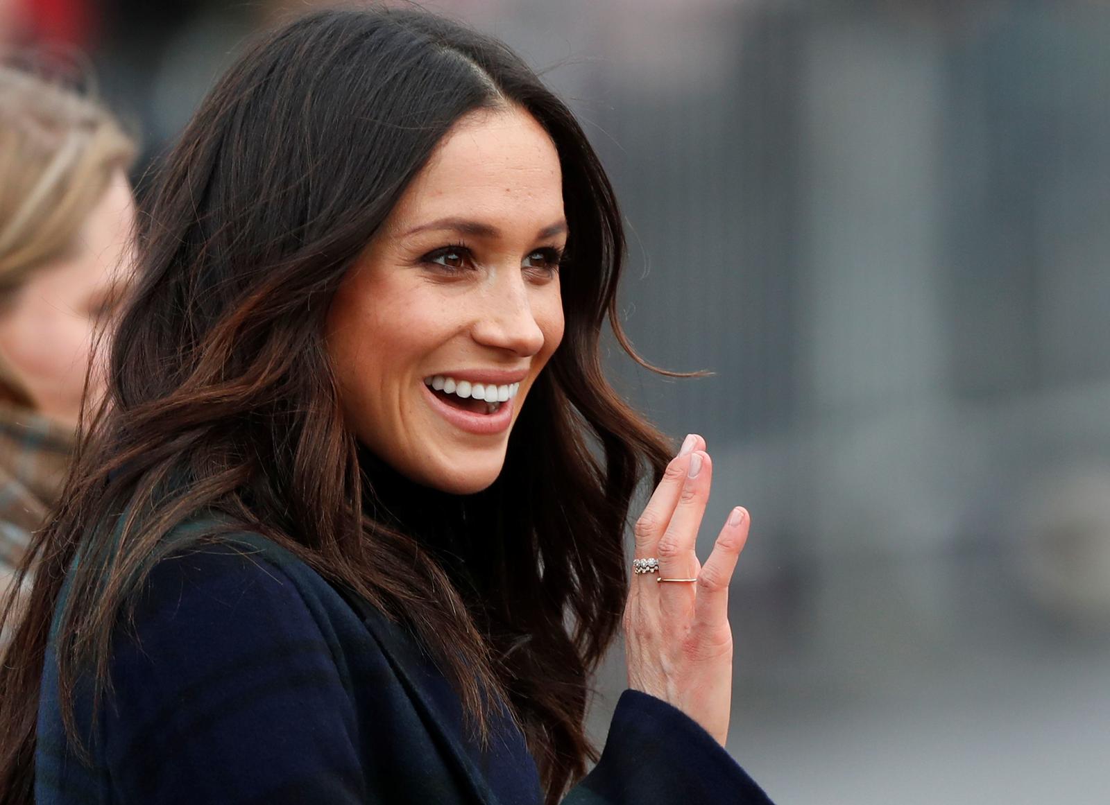 Meghan Markle, fiancee of Britain’s Prince Harry, waves as she arrives for a visit to Edinburgh