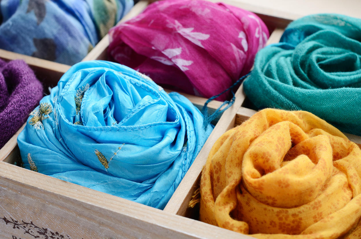 Set of colorful scarves in wooden box