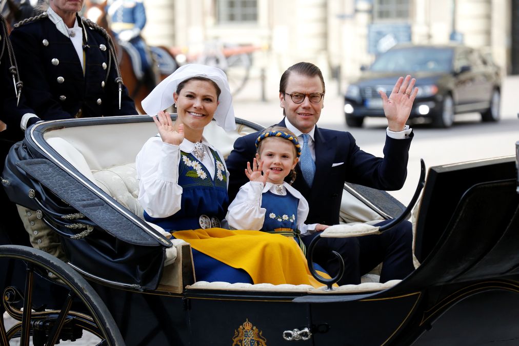 Swedish Crown Princess Victoria, Princess Estelle and Prince Daniel ride an open carriage to the official National Day of Sweden celebrations at the Skansen open-air museum in Stockholm