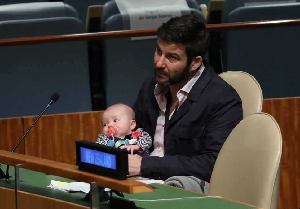 Clarke Gayford, partner to New Zealand Prime Minister Jacinda Ardern holds their baby Neve at the Nelson Mandela Peace Summit during the 73rd United Nations General Assembly in New York