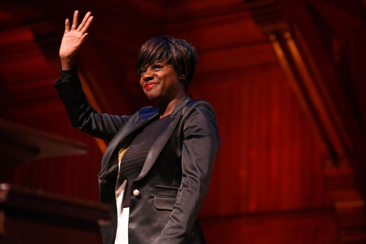 Actress Viola Davis gestures to the crowd after receiving the Harvard Foundation’s arts medal during the 32nd annual Cultural Rhythms Festival in Sanders Theatre at Harvard University in Cambridge