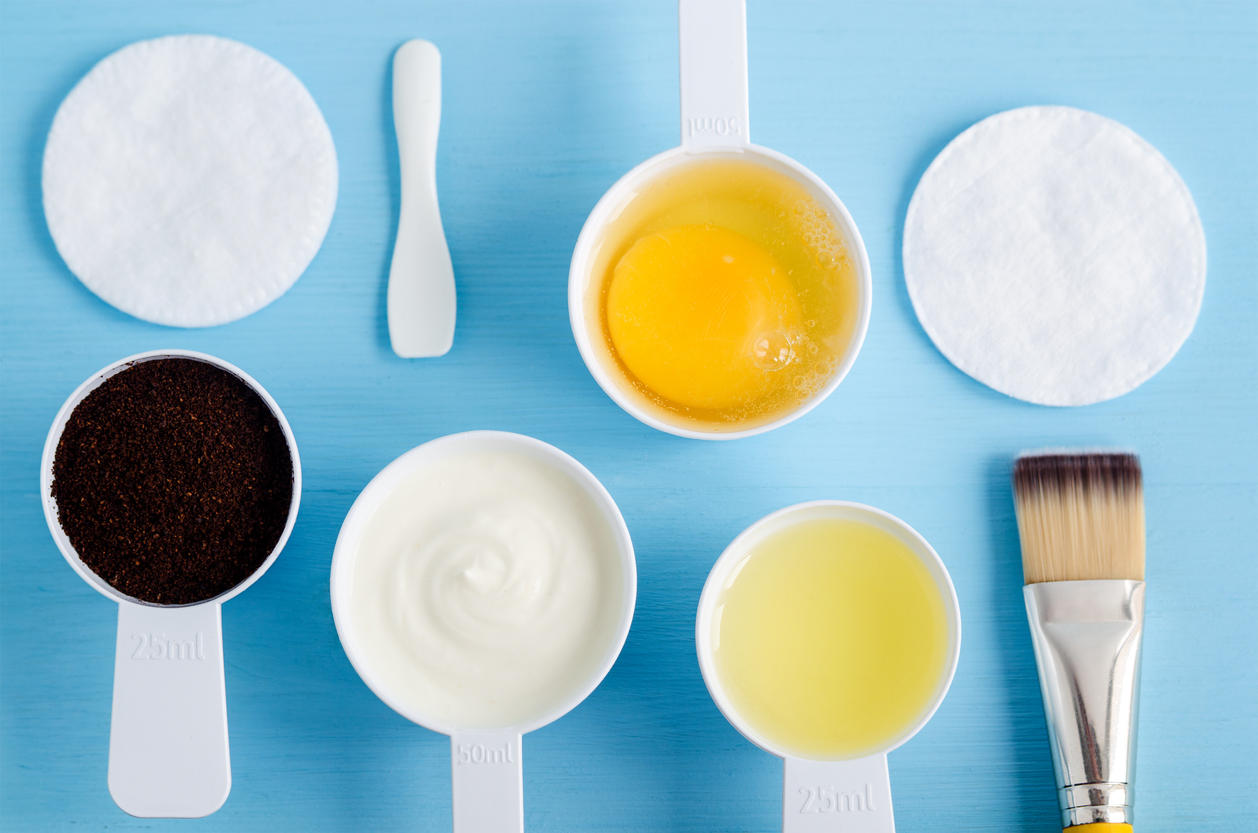 Sour cream (greek yogurt), raw egg, ground coffee and olive oil in the small scoops. Ingredients for preparing diy masks, scrubs, moisturizers. Homemade cosmetics. Top view, copy space.