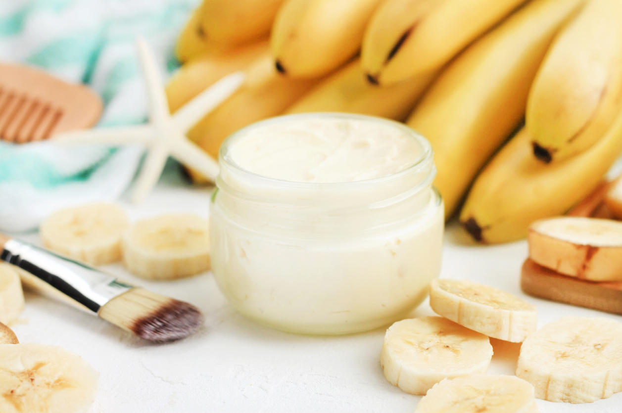 Homemade banana skincare beauty treatment mask. Jar of aromatic body butter,  fresh ripe yellow fruit