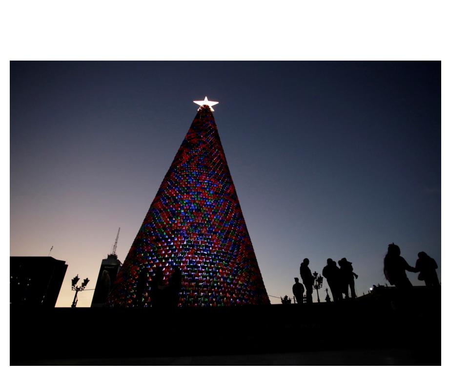 People stand next to a Christmas tree made of plastic chairs at the Macroplaza in Monterrey, Mexico November 26, 2018. Picture taken November 26, 2018. REUTERSDaniel Becerril