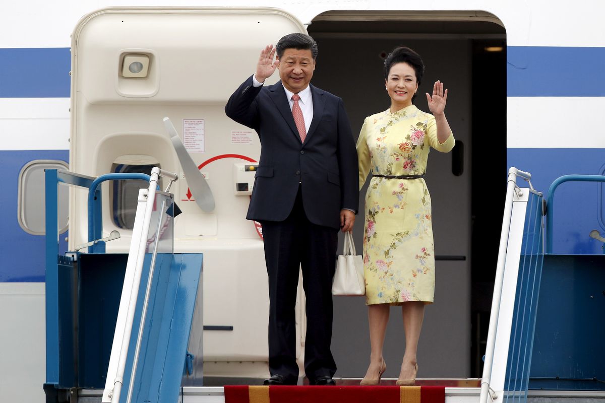 China’s President Xi Jinping and his wife Peng Liyuan arrive at Noi Bai International airport in Hanoi