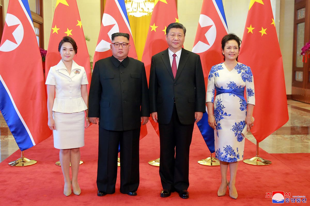 North Korean leader Kim Jong Un and his wife Ri Sol Ju pose beside Chinese President Xi Jinping and his wife Peng Liyuan in Beijing, China