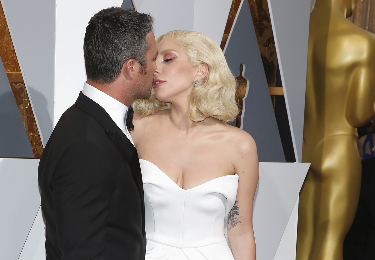 Lady Gaga moves to kiss fiance Kinney at the 88th Academy Awards in Hollywood