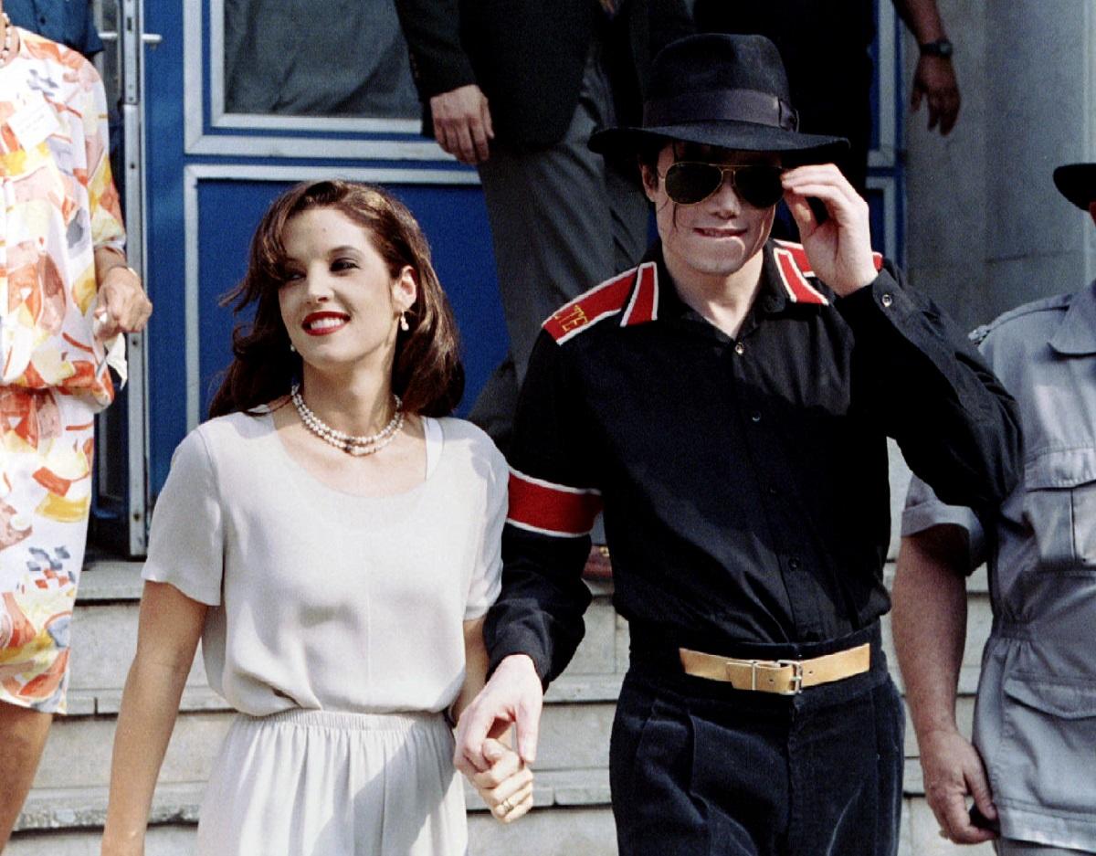 Popstar Michael Jackson and his bride Lisa Marie Presley-Jackson hold each others hands August 6..