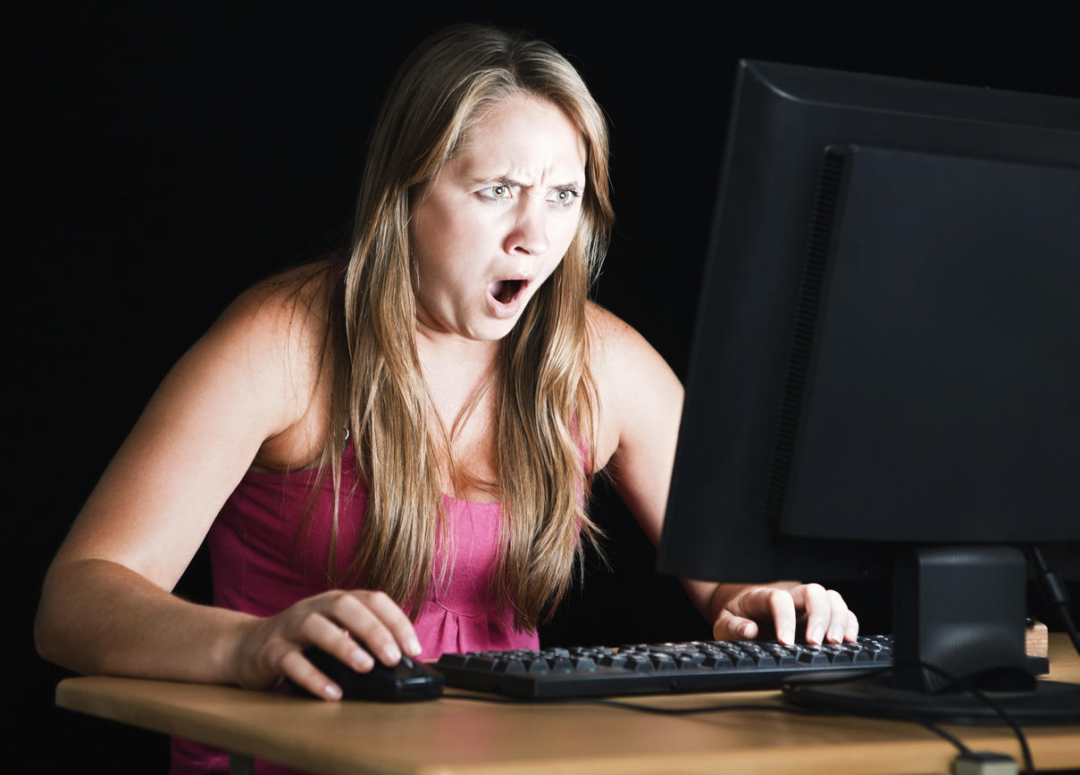 Pretty blonde is shocked by what’s on computer monitor