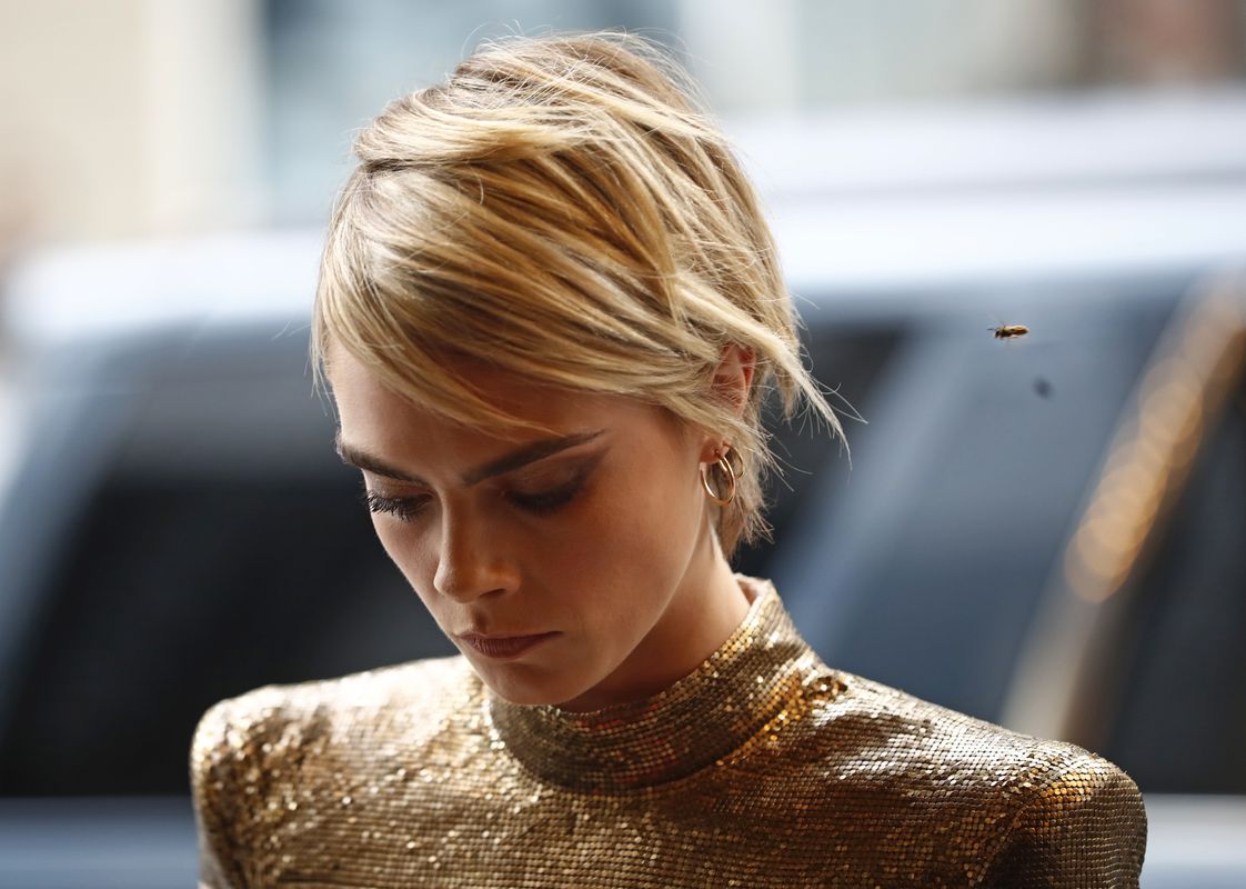 A bee flies near Cara Delevingne as she arrives at the world premiere of “Her Smell” at the Toronto International Film Festival