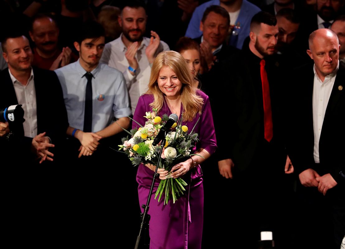 Slovakia’s presidential candidate Zuzana Caputova receives flowers at her party’s headquarters in Bratislava