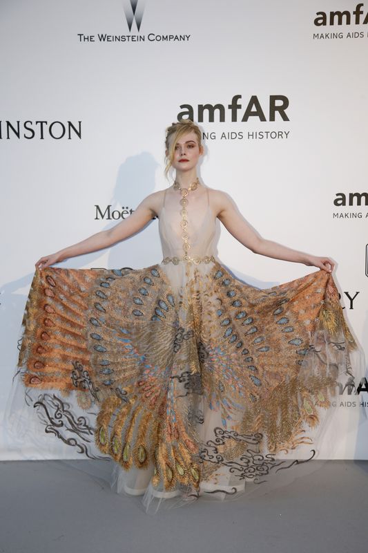 Actress Elle Fanning poses during a photocall as she arrives to attend the amfAR’s Cinema Against AIDS 2016 event, during the 69th Cannes Film Festival, in Antibes