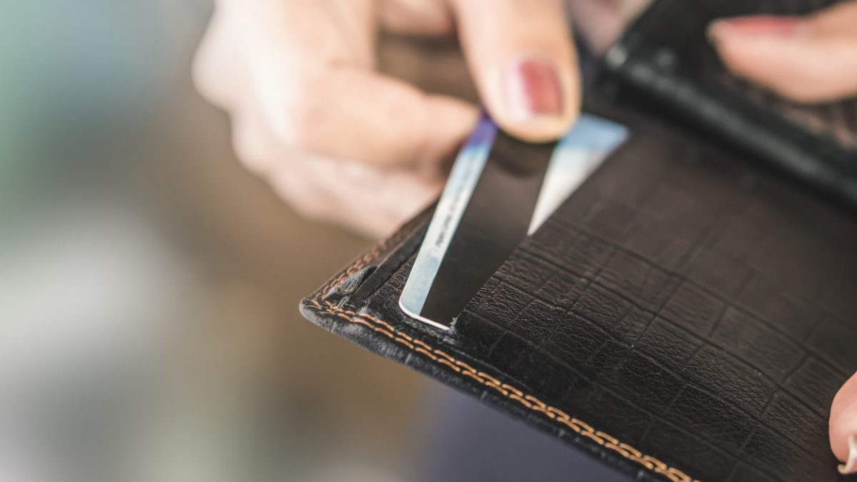woman hand taking credit card from black purse