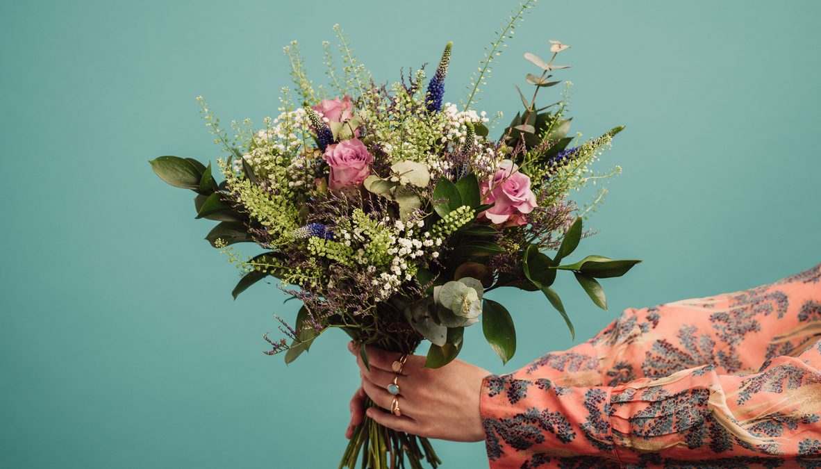 Woman holding a big bouquet of flowers