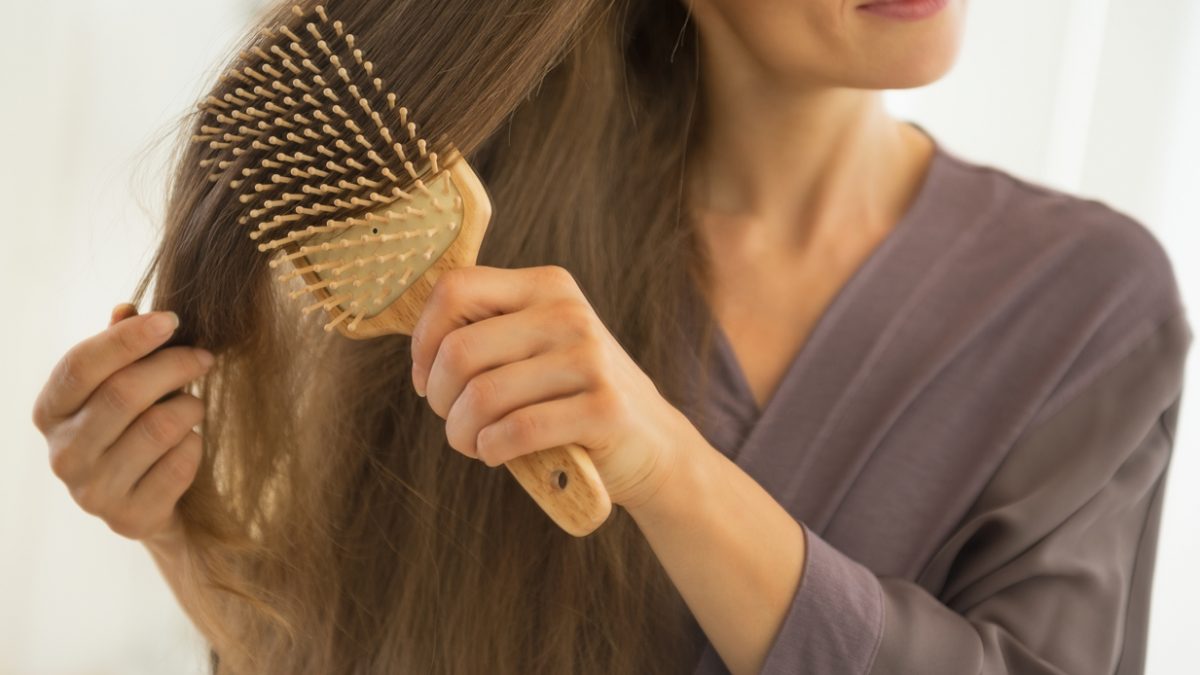 closeup on young woman combing hair